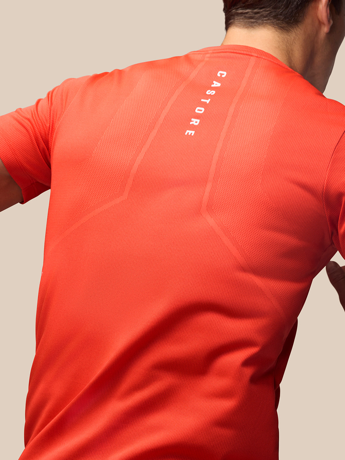 Back view of red Apex Training T Shirt featuring Castore branding running down the spine