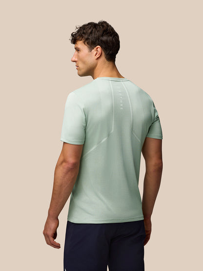 Back view of mint green Apex Training T Shirt on model showing textured knit fabric and back branding