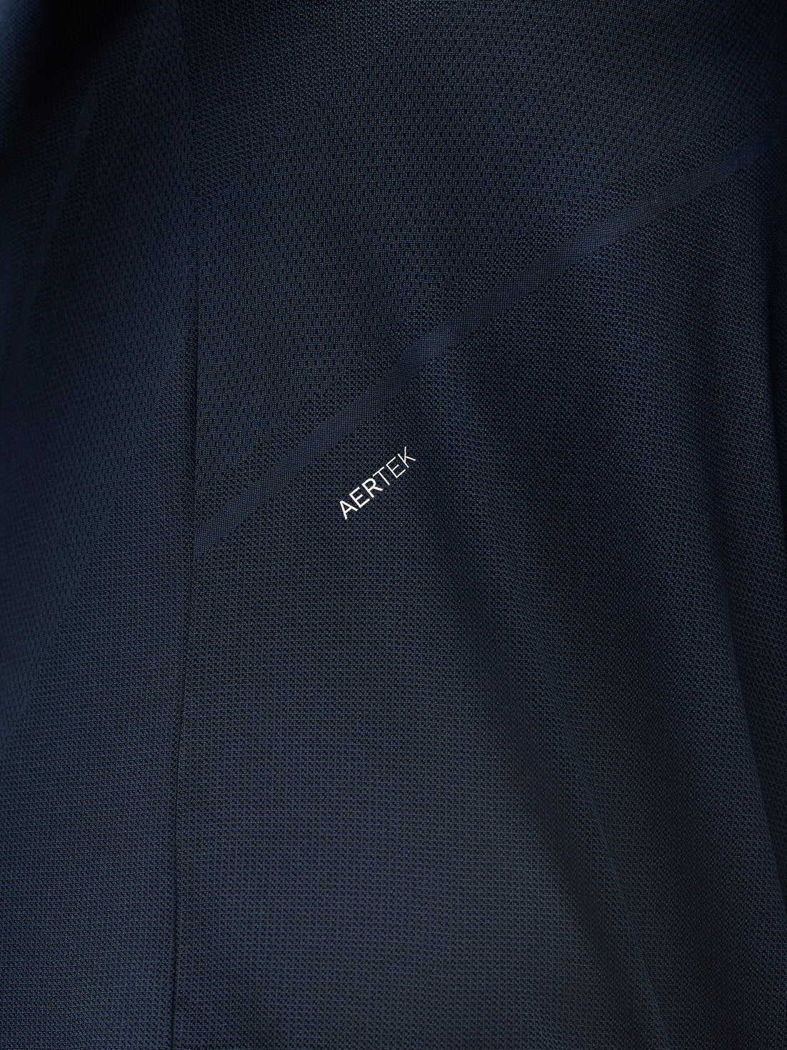 Close up of navy Apex training knit fabric with mesh texture and Aertek branding
