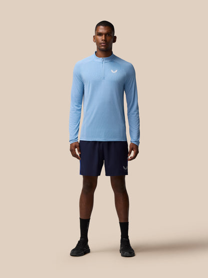 Front view of a man wearing sky blue Apex Training 1/4 Zip Top with a white logo on the chest.