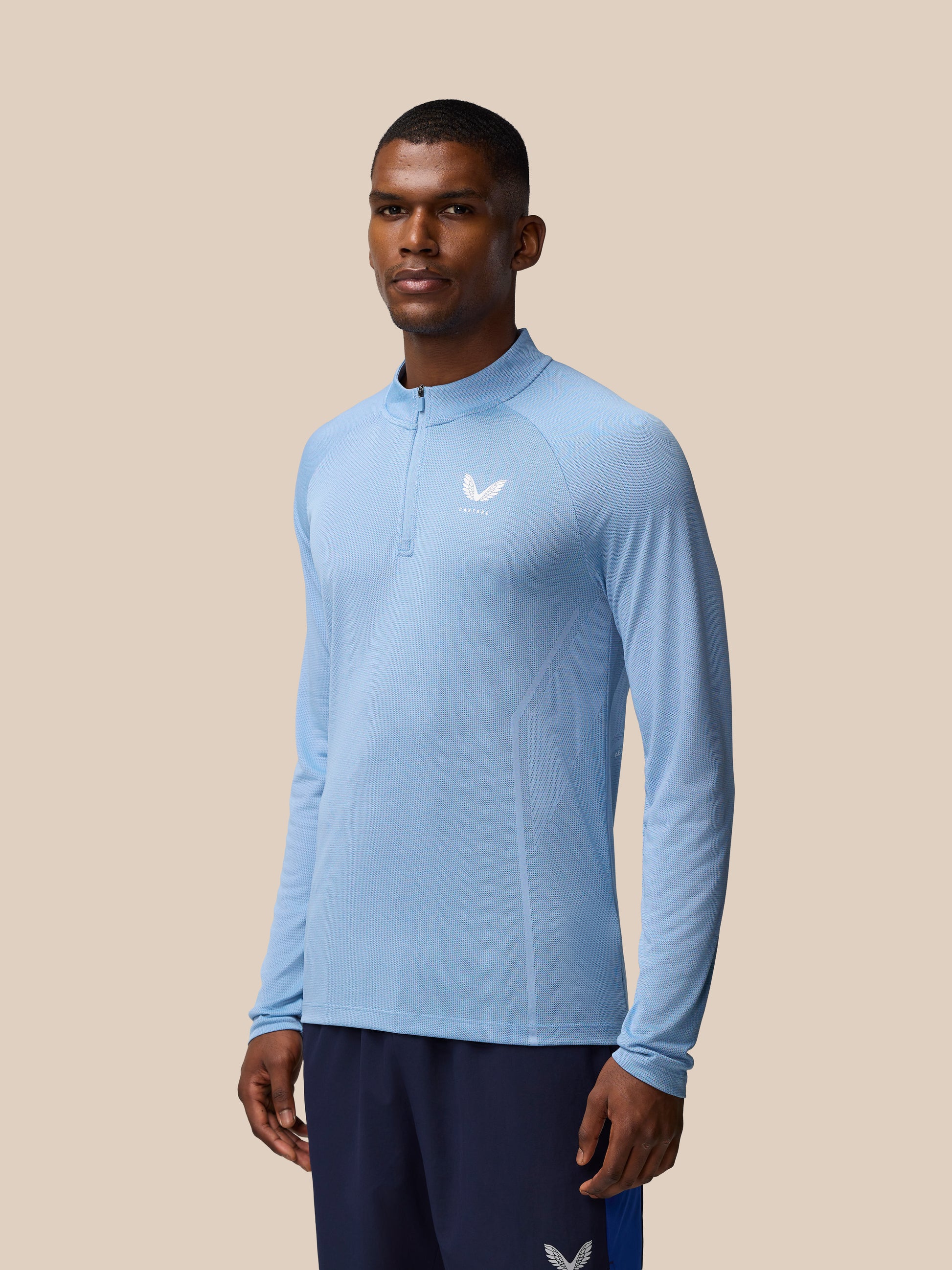 Model wearing sky blue Apex Training 1/4 Zip Top with front quarter zip and breathable knit texture