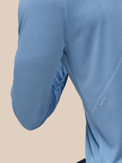 Close-up of sky blue Apex Training top fabric with breathable mesh knit and branding along the sleeve