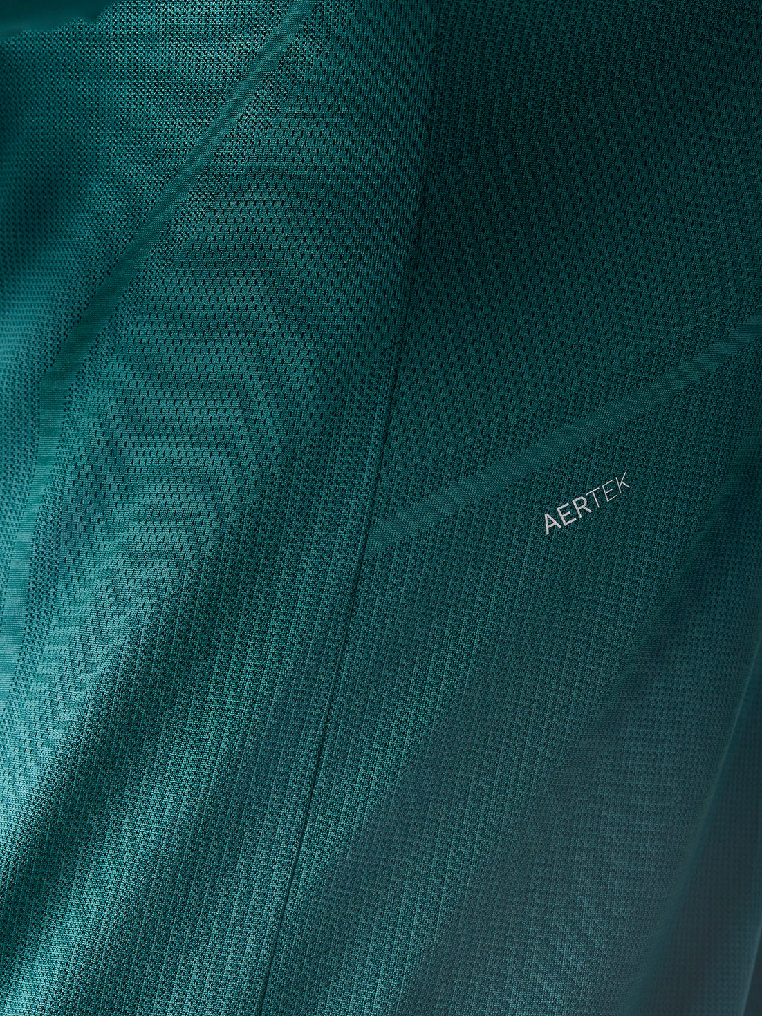 Close up of teal AerTek mesh fabric with visible AERTEK branding
