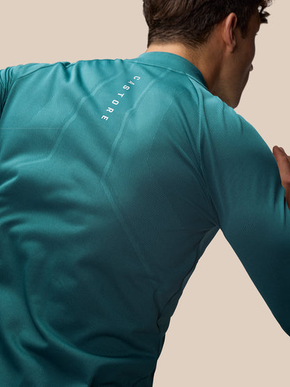 Back view of aqua Apex Training 1/4 Zip Top displaying Castore branding along the back.