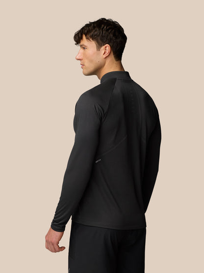 Male model wearing Apex Training 1/4 Zip Top in black gunmetal, back view showing reflective branding and seam detailing