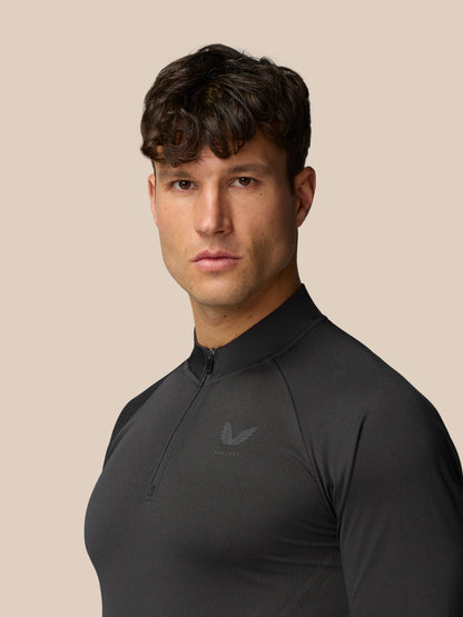 Male model wearing Apex Training 1/4 Zip Top in black gunmetal, three quarter view highlighting knit texture and zip collar