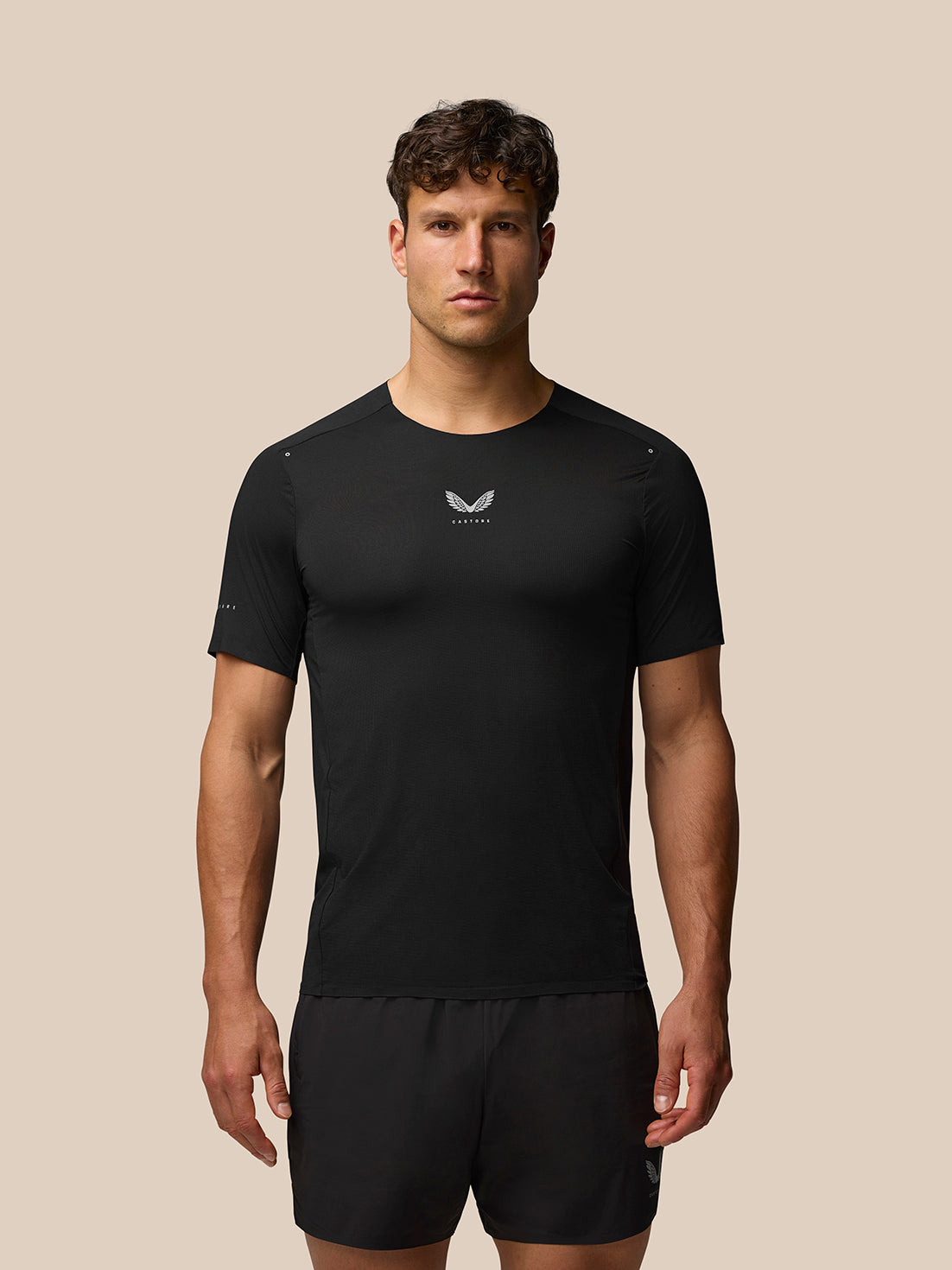 Front view of Zone Training T-Shirt in black on a male model with a small white Castore logo at the chest