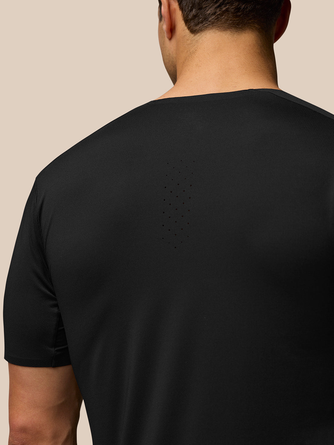Back view of Zone Training T-Shirt in black showing dotted back ventilation.