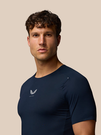 Male model wearing navy Zone Training T-Shirt with Castore logo on chest, close-up of torso