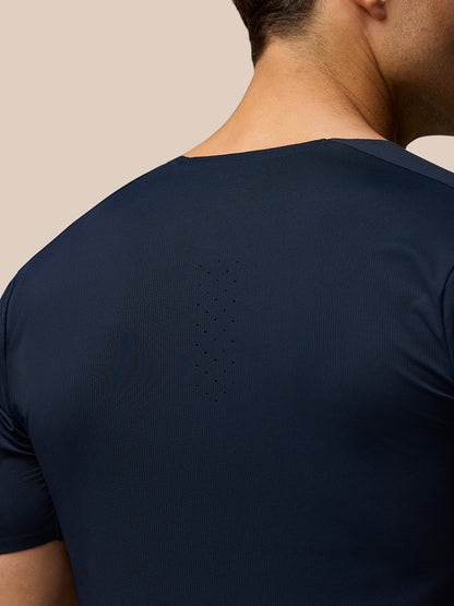Back view of male model in navy Zone Training T-Shirt showing upper back ventilation perforations