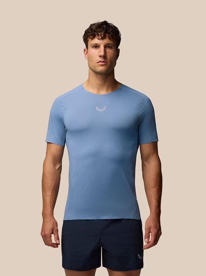 Male model wearing blue Zone Training T-Shirt in athletic fit with reflective branding on chest and cuff
