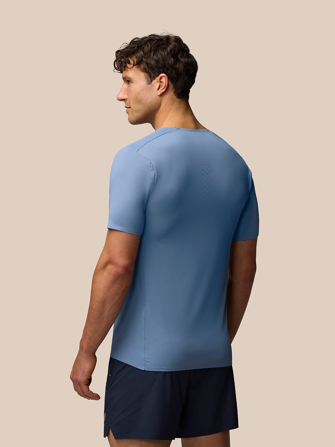 Blue Zone Training T-Shirt shown from the back on a model highlighting upper back ventilation perforation