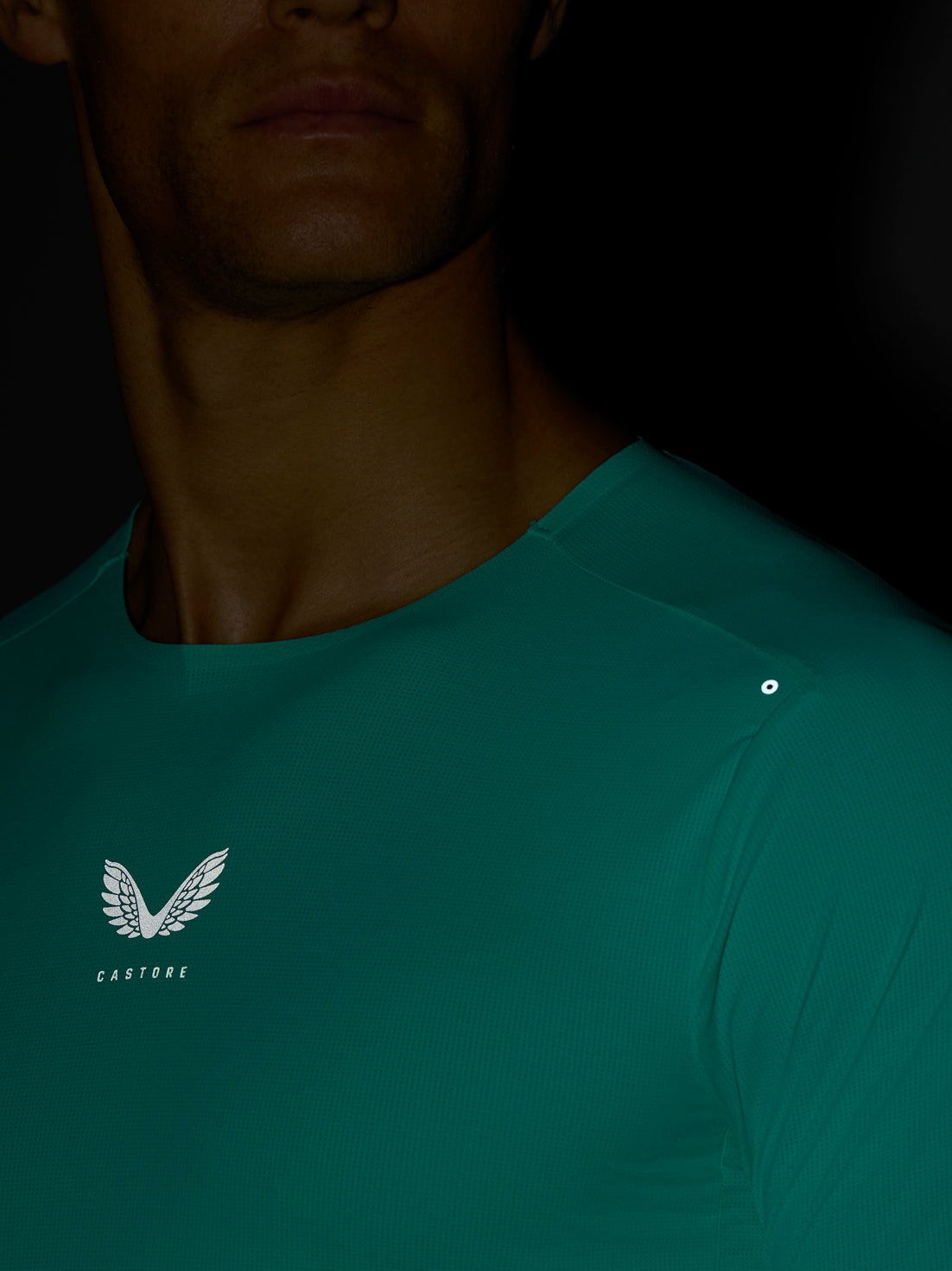 Close-up of light aqua Zone Training T Shirt showing reflective chest logo