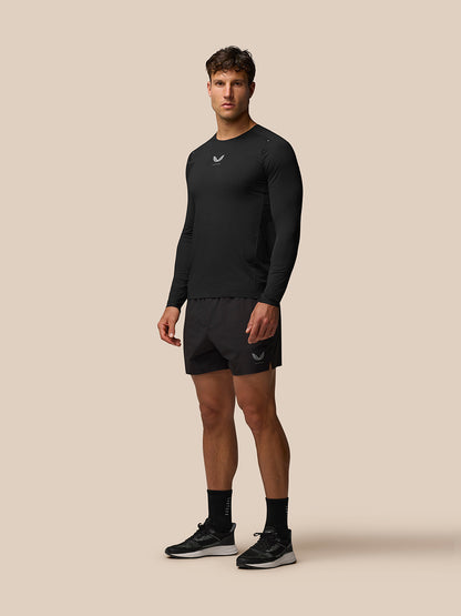 Full-body view of a man wearing a black Zone Training T-Shirt with long sleeves and athletic fit
