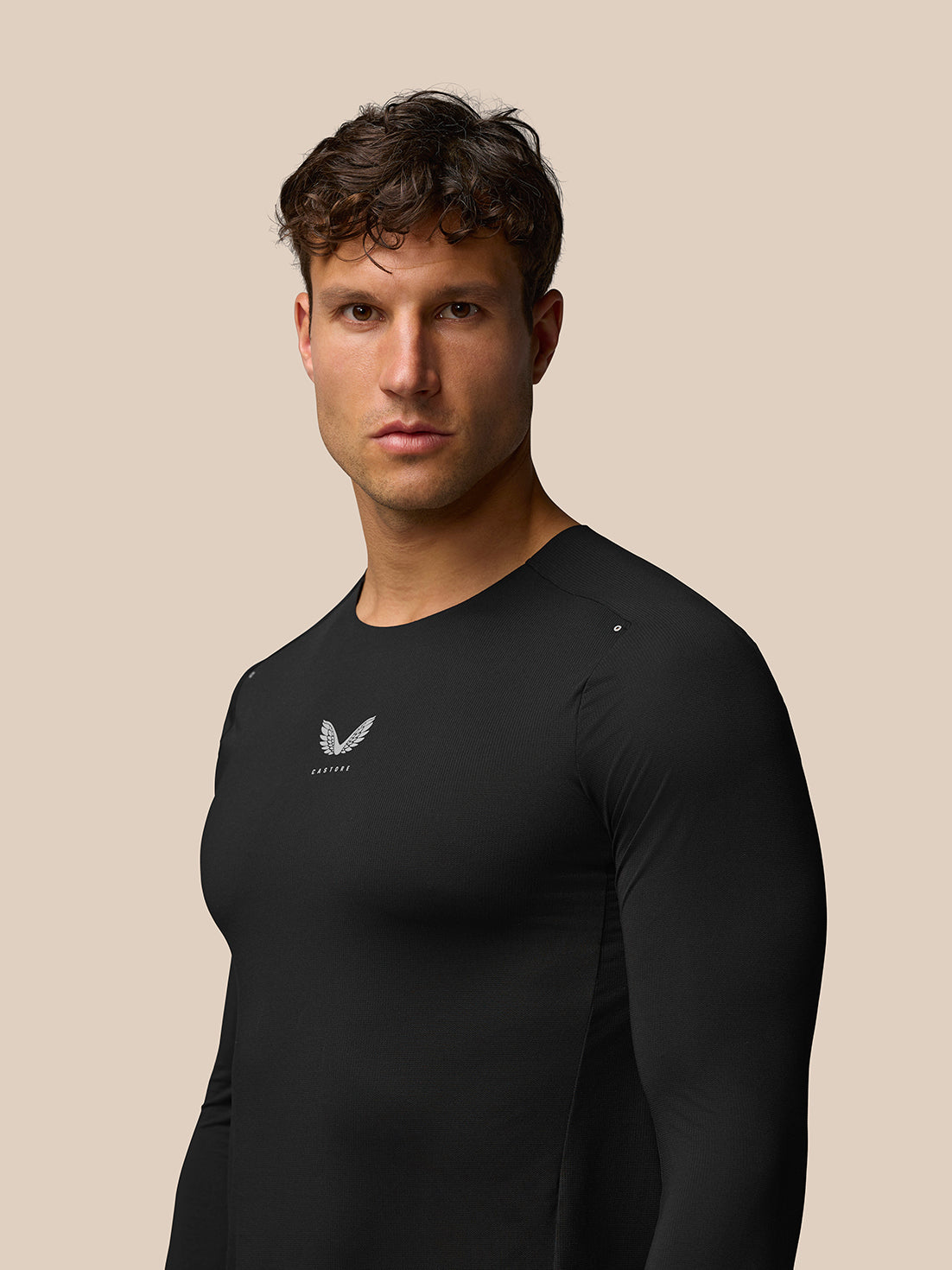Three quarter view of male model wearing black Zone Training T Shirt with chest logo