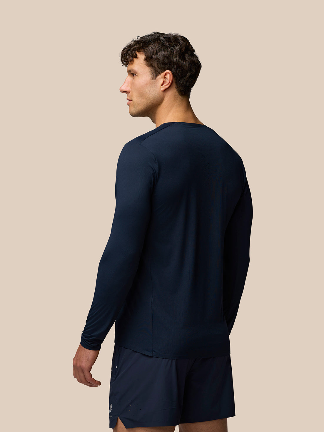 Back view of a man wearing a navy Zone Training T Shirt long sleeve