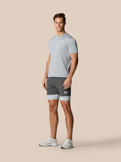 Full body shot of a man wearing Flow Training T-Shirt Grey with honeycomb pattern and dark shorts