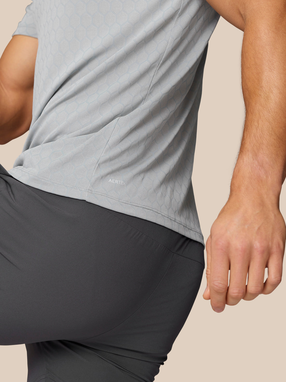 Back view of Flow Training T-Shirt Grey with honeycomb pattern and AerTek branding near the hem