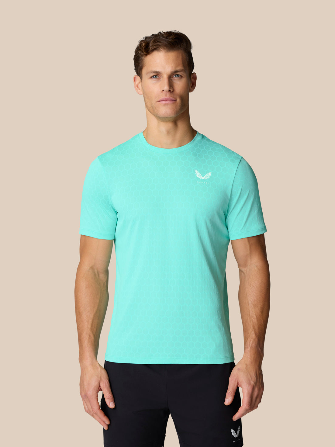 Male model in light aqua Flow Training T Shirt with AerTek knit for breathability