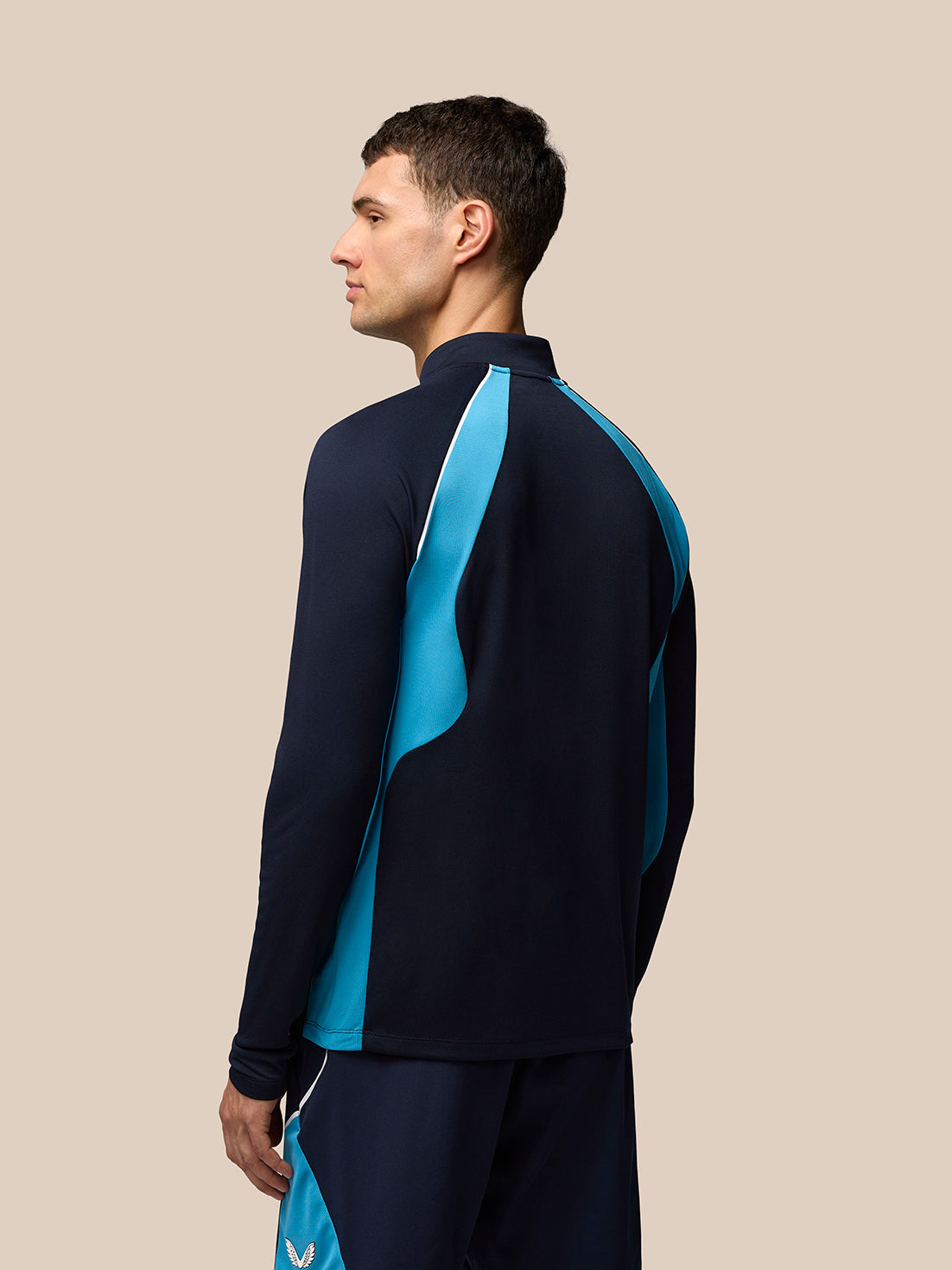 Back view of navy Tennis Aeromesh long sleeve top showing cyan side panels and white piping.
