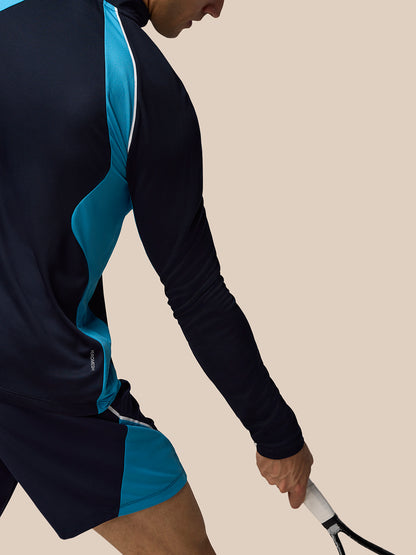 Side view of navy tennis top with teal side panel and white trim and Aeromesh branding at hem