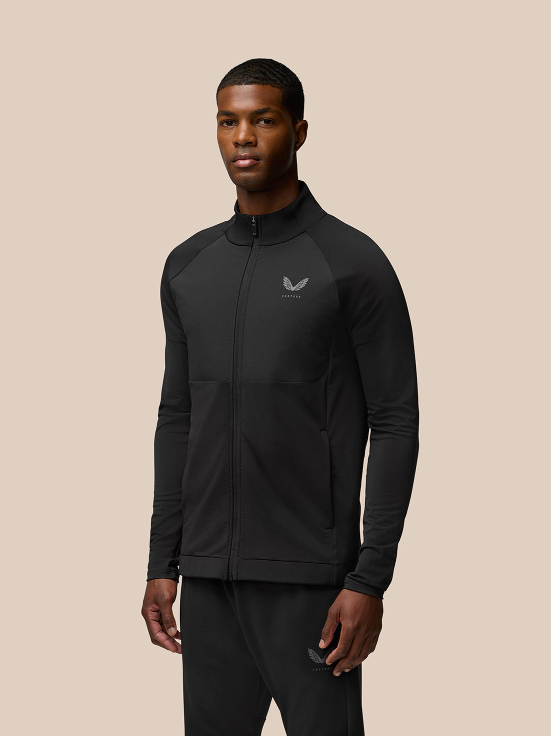 Man wearing Flow Training Jacket in black with full zip and Castore logo on chest
