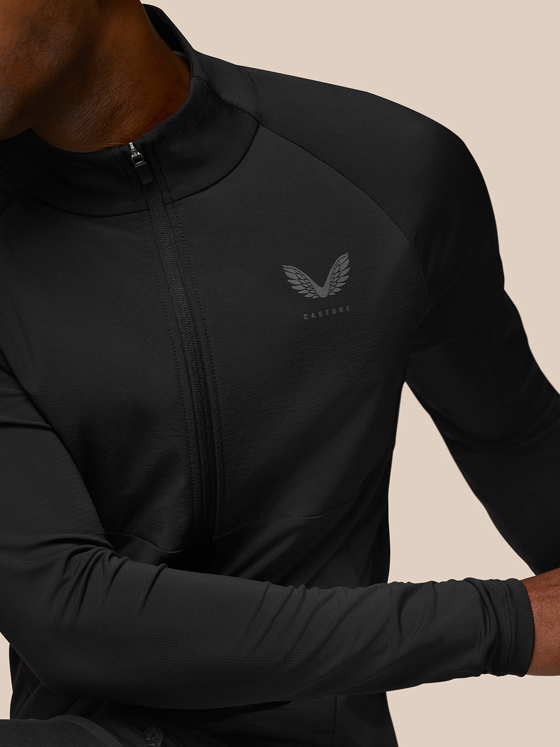 Close-up of Flow Training Jacket chest showing full-length zipper and Castore wing logo