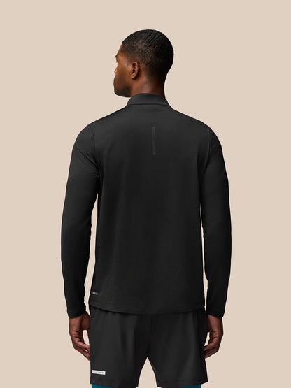 Back view of a man wearing Flow Sweatshirt Black with funnel collar and curved hem.