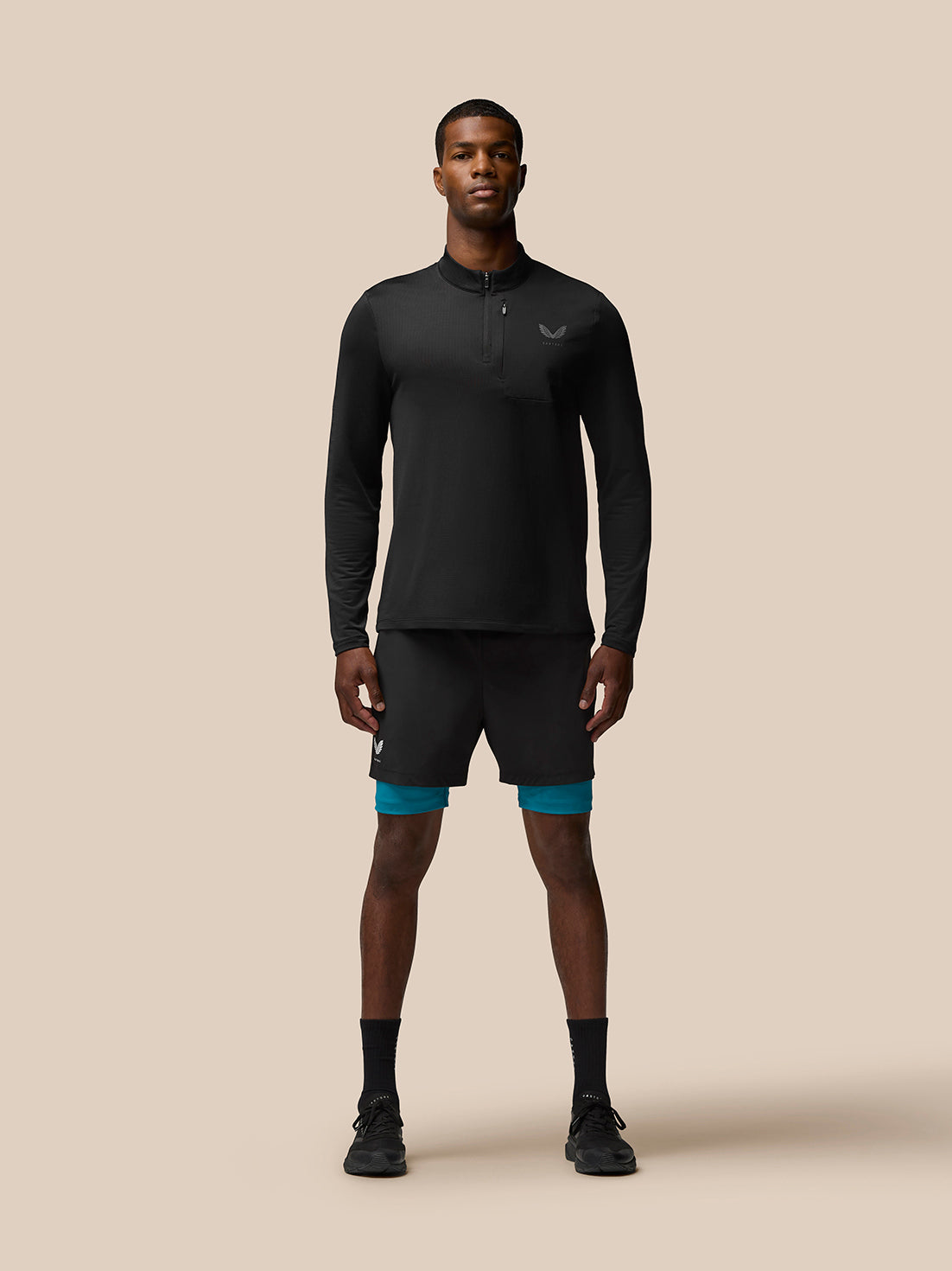 Male model wearing black Flow Sweatshirt with funnel collar, quarter zip and chest pocket