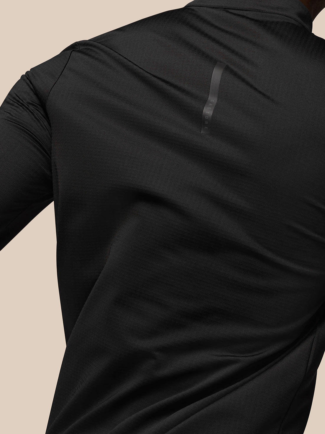 Close up of Flow Sweatshirt Black back showing textured fabric and AERTEK label near the hem.