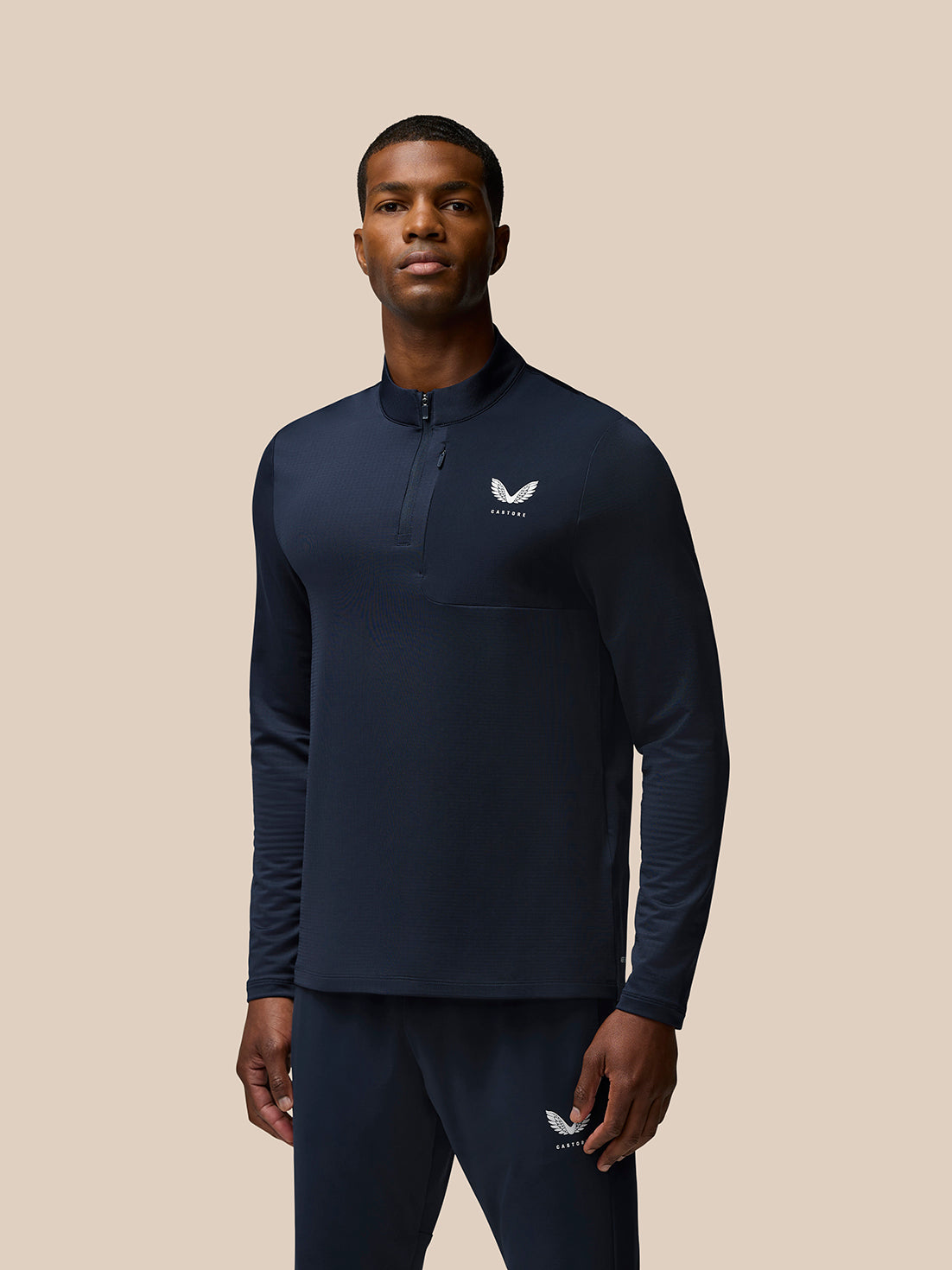 Model wearing navy Flow Quarter Zip Sweater Top with funnel collar and woven chest pocket