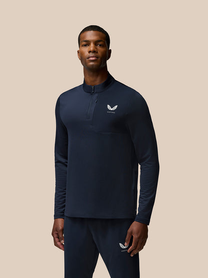 Model wearing navy Flow Quarter Zip Sweater Top with funnel collar and woven chest pocket