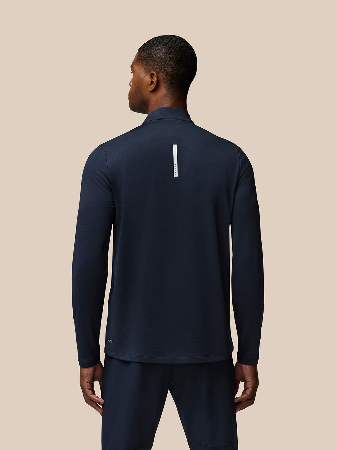 Back view of navy Flow Quarter Zip Sweater Top showing Castore branding down the center back