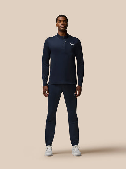 Full-body front view of a man wearing navy Flow Quarter Zip Sweater Top with matching joggers in a studio