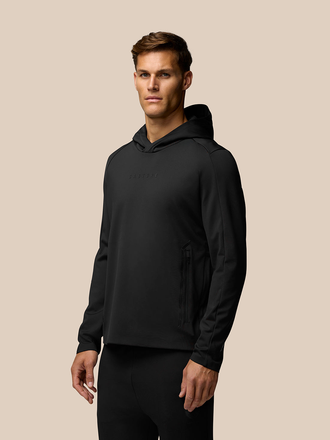 Male model wearing black Garcia water resistant hoodie with hood up and zip side pockets.