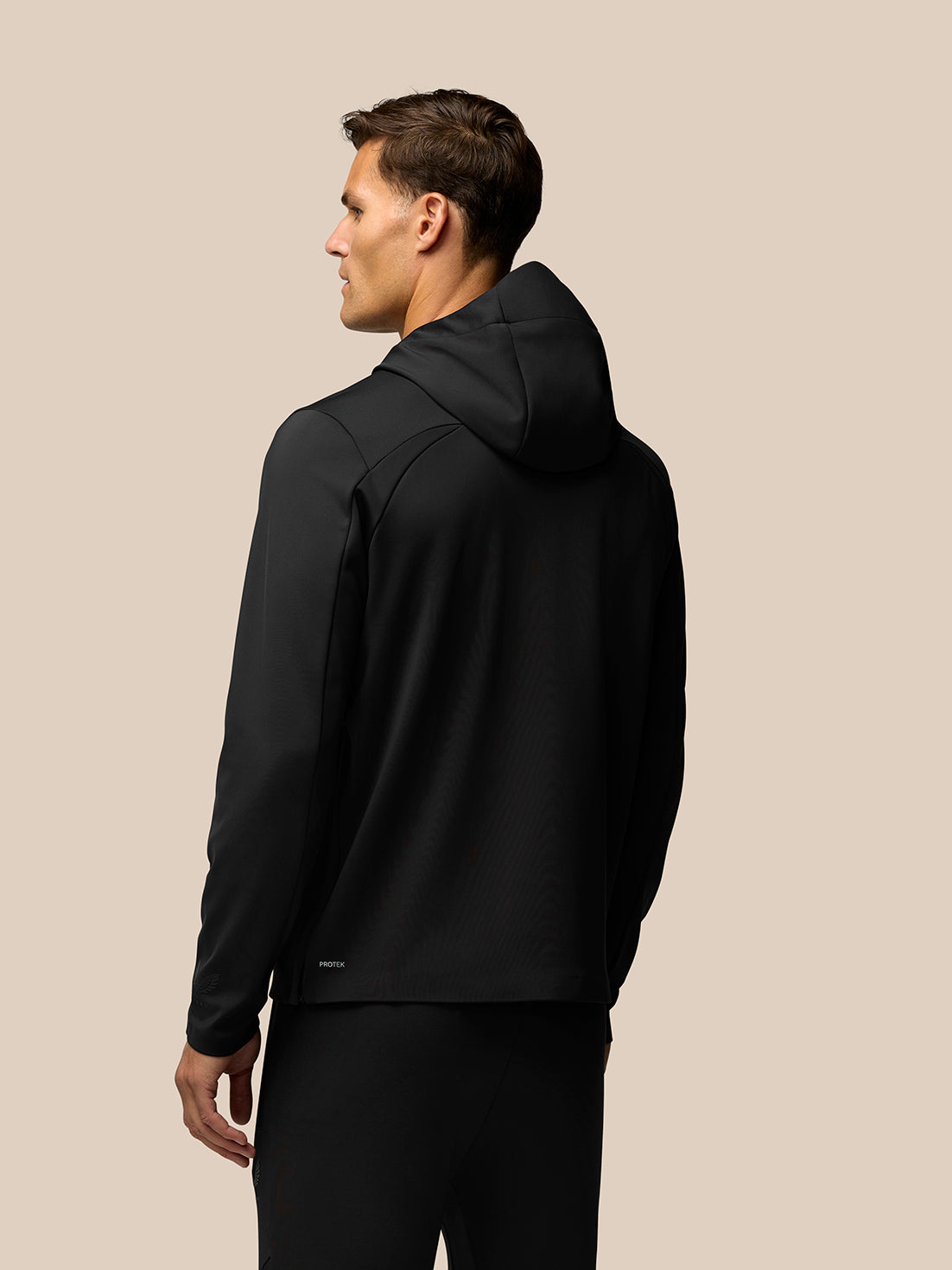 Back view of male model in black Garcia water resistant hoodie with hood and streamlined silhouette.