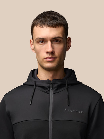 Back view of a man in a black hooded jacket with a clean silhouette