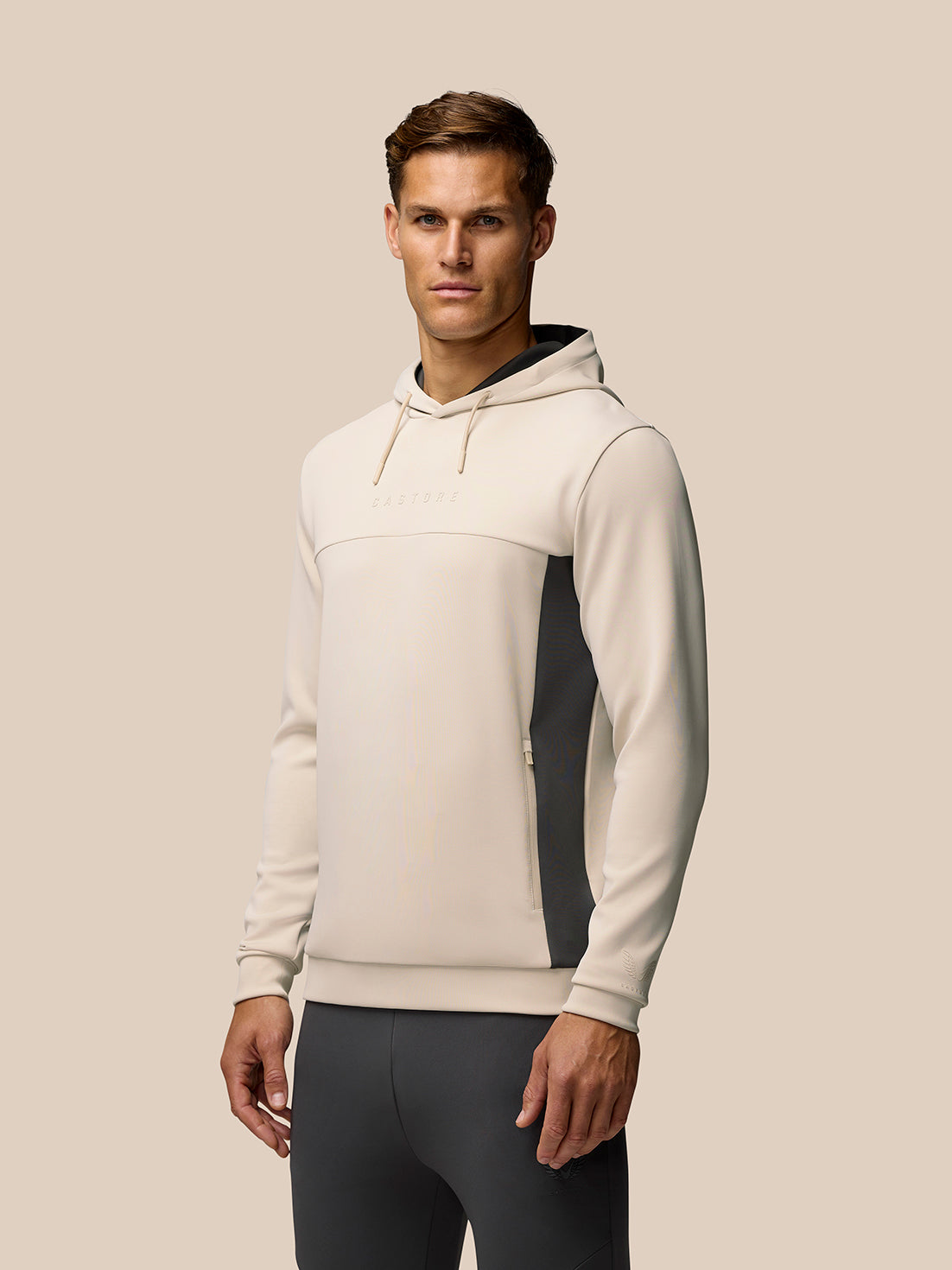 Beige Flex Lifestyle Hoodie on a man with contrasting side panels and subtle branding on chest.