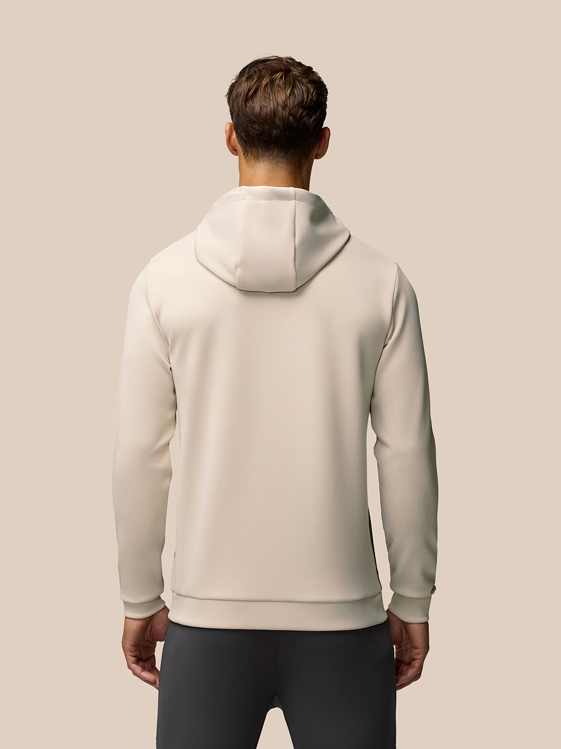Back view of beige Flex Lifestyle Hoodie on male model with hood down