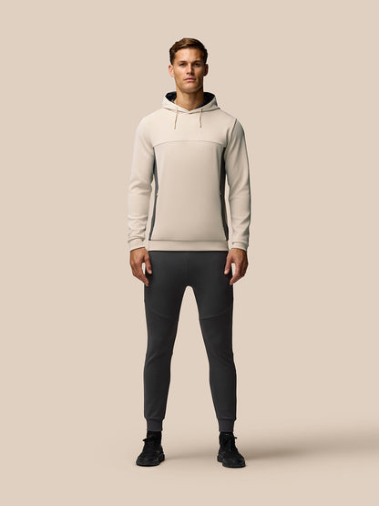 Male model wearing beige Flex Lifestyle Hoodie with contrast side panels and drawstring hood