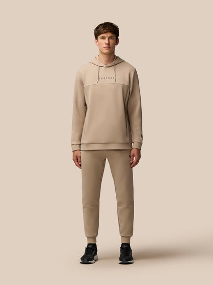 Back view of mushroom beige Flex Lifestyle Hoodie showing the hood and ProTek logo at the lower back.
