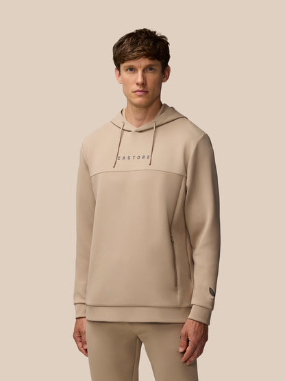 Male model wearing mushroom beige Flex Lifestyle Hoodie with a drawstring hood and Castore wordmark on the chest.