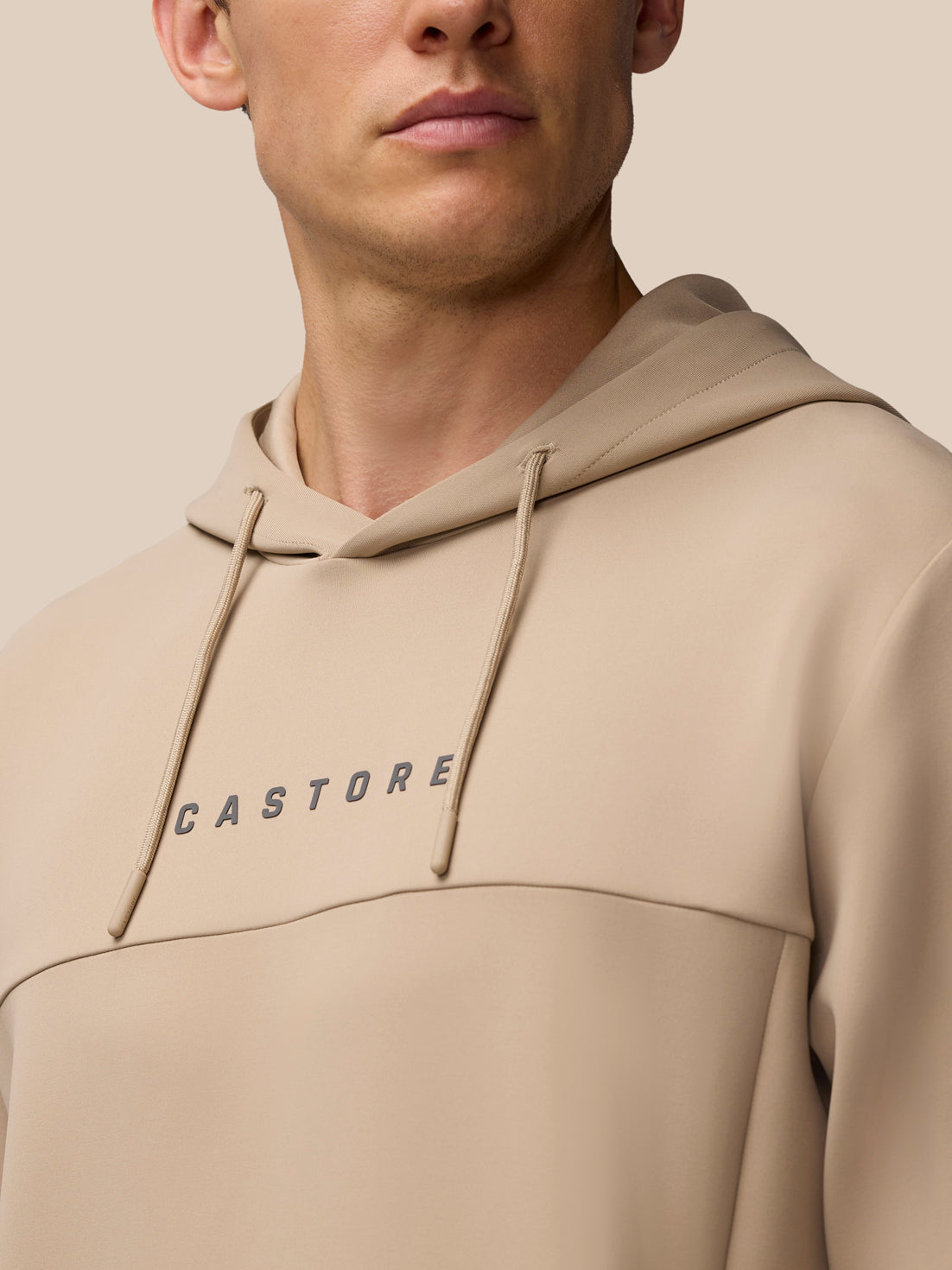 Mushroom color Flex Lifestyle Hoodie chest area with Castore wordmark visible.