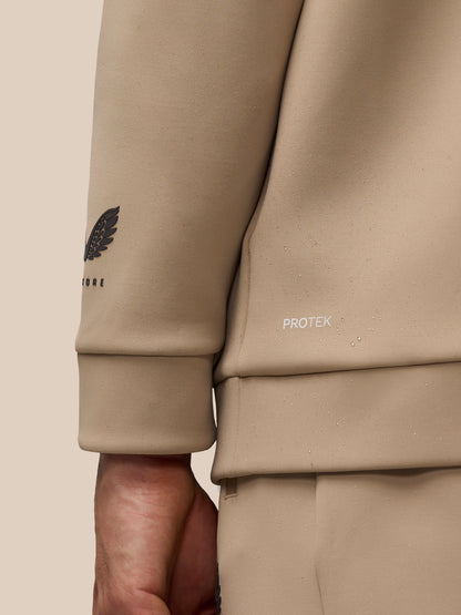 Close up of mushroom hoodie sleeve showing the winged Castore logo and ProTek branding.