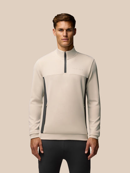 Beige Flex Lifestyle 1/4 Zip top on a model with high collar and zip placket