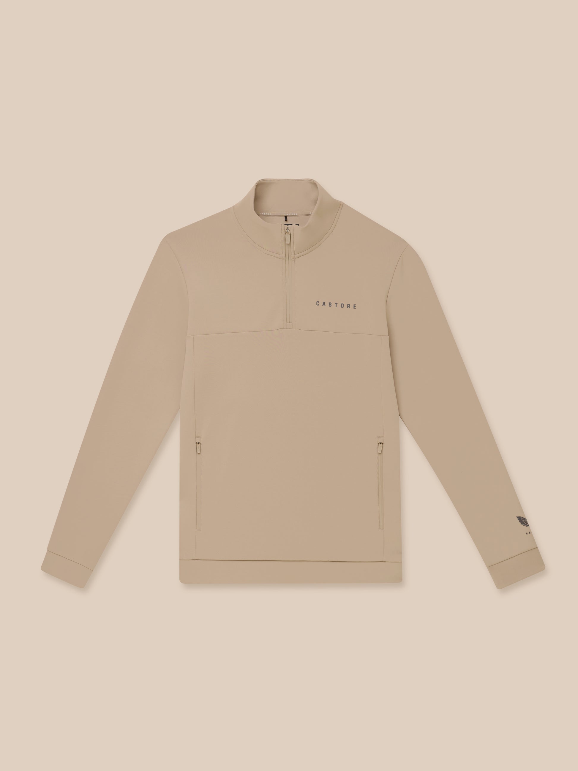 Close up of beige Flex Lifestyle 1/4 Zip showing chest Castore wordmark and quarter zip detail