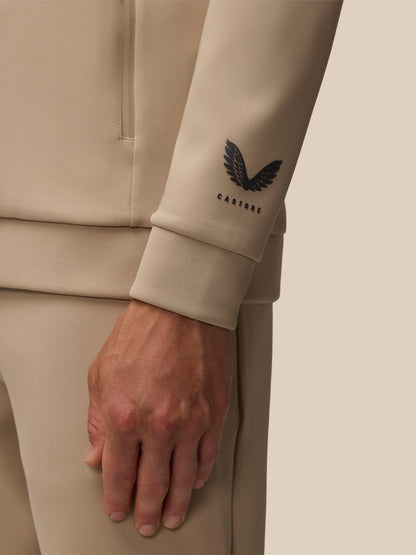 Beige sleeve close up showing Castore wing logo on the cuff