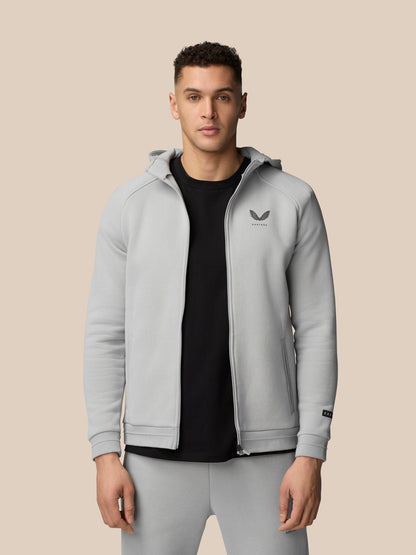 Close-up of a man wearing a light grey Adapt Fleece Zip-Through Hoodie showing the chest logo and zip