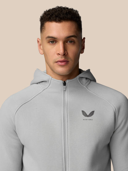Front view of a man in a light grey Adapt Fleece Zip-Through Hoodie, zipped up with small chest logo