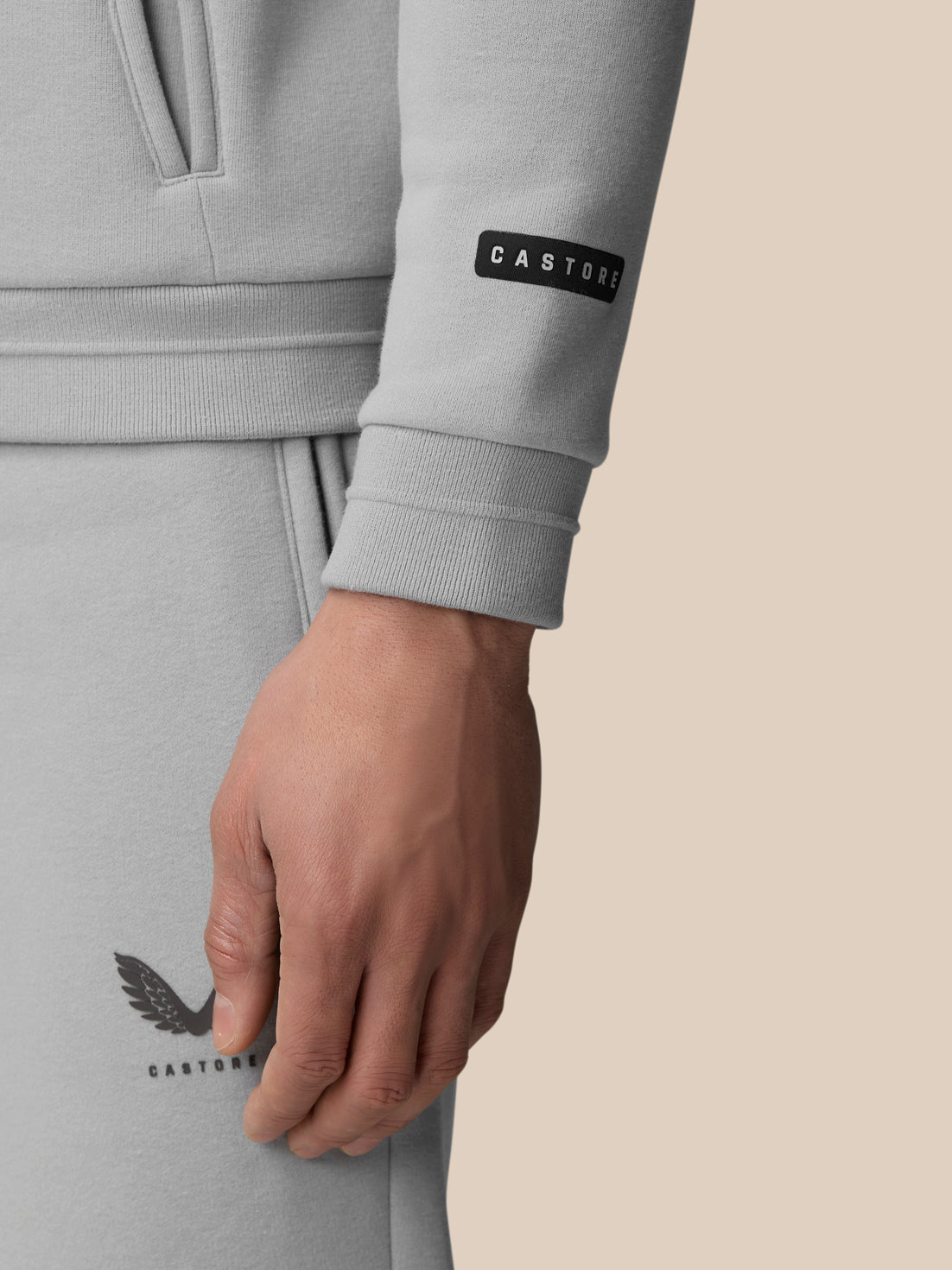 Close-up of a grey Adapt Fleece Zip-Through Hoodie sleeve showing the cuff and Castore badge.